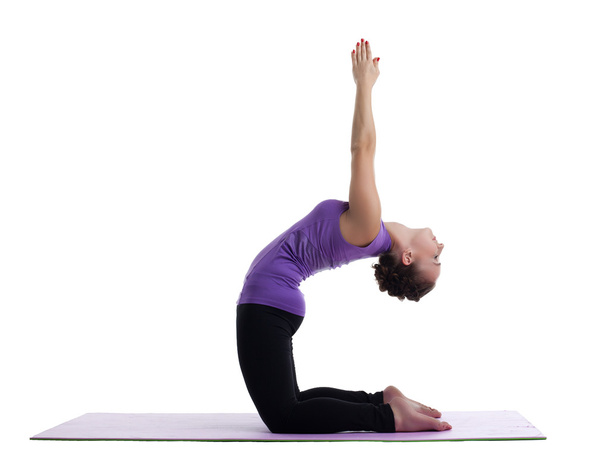 Woman yoga instructor posing on rubber mat - Photo, image