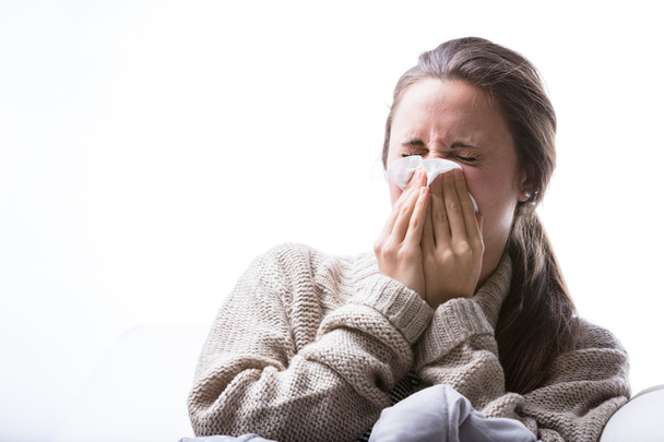 woman blowing her nose because of a cold - Photo, Image