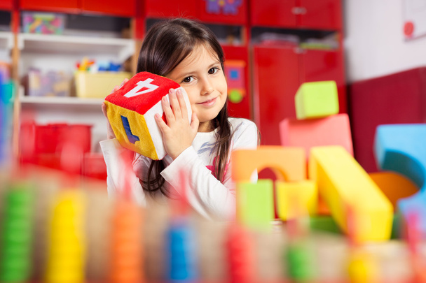 Preschooler child playing with colorful toy blocks. - Foto, immagini