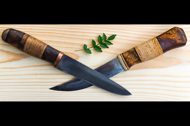 two knives, a cross and a green leaf roses - Fotografie, Obrázek