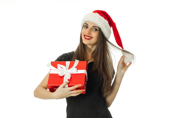 young woman in santa hat with red gift - Fotó, kép