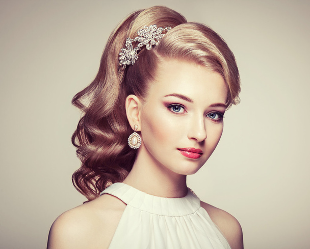 Fashion portrait of young beautiful woman with elegant hairstyle - Фото, изображение