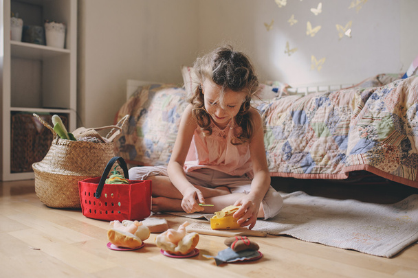little child girl playing in her room with toy food, cooking and having fun at home - Foto, Imagem