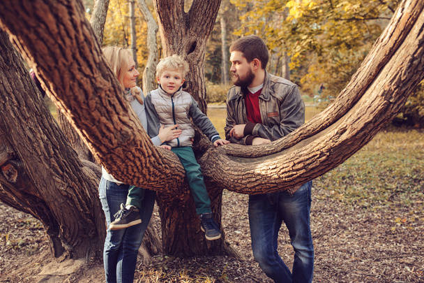 happy family spending time together outdoor. Lifestyle capture, rural cozy scene. Father, mother and son walking in forest - Fotografie, Obrázek