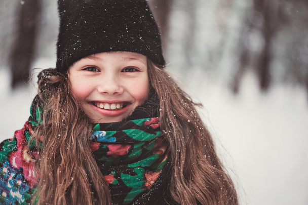 happy dreamy child girl walking in snowy winter forest - Foto, Bild