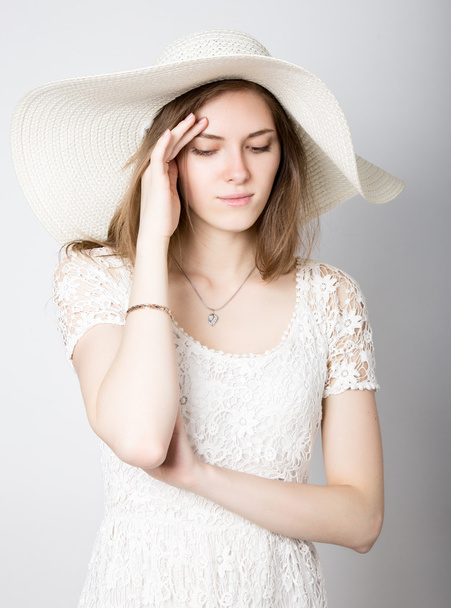 beautiful girl in broad-brimmed hat posing and expresses different emotions. headache, sadness, fatigue - Фото, изображение