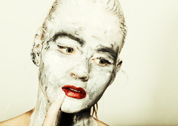 abstract art makeup. Face and neck girls smeared with gray colors and bright red lips. Holi Festival - Foto, imagen