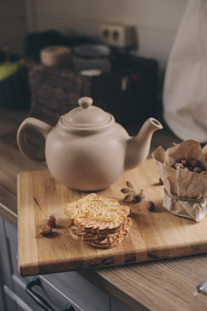 Tea pot and cookies in rustic grey kitchen interior. Slow living in country house concept. Cozy morning at home - Foto, Bild