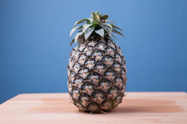 Pineapple on wooden table - Foto, Imagen