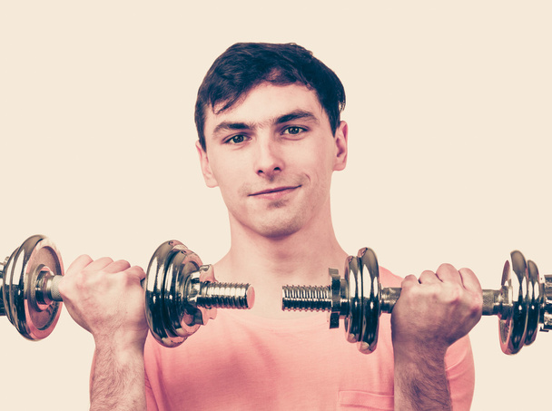 Man exercising with dumbbells lifting weights  - Valokuva, kuva