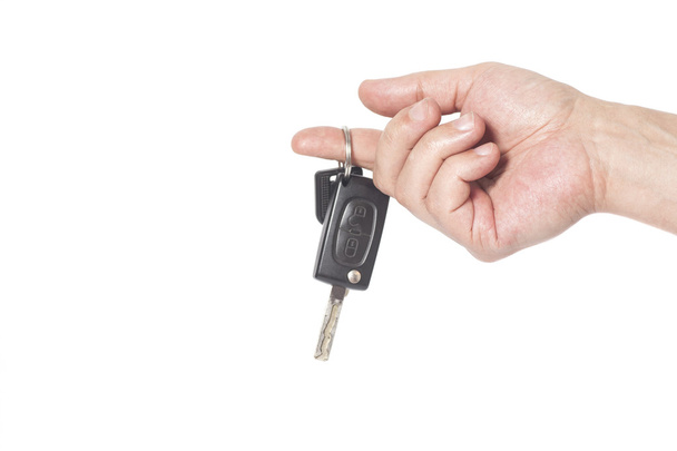 Hand with a car keys isolated on white background - Foto, imagen