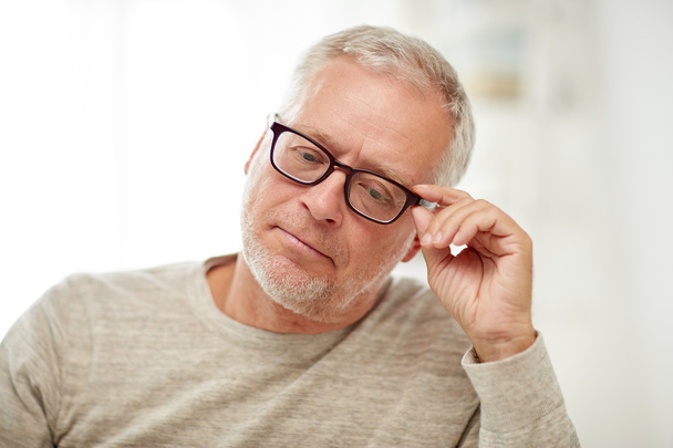 close up of senior man in glasses thinking - Foto, afbeelding