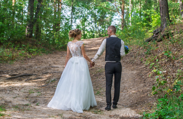 Wedding couple in green forest - Foto, afbeelding