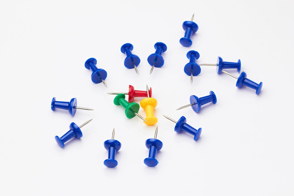 Blue, yellow, red and green thumbtacks on a white background. - Zdjęcie, obraz