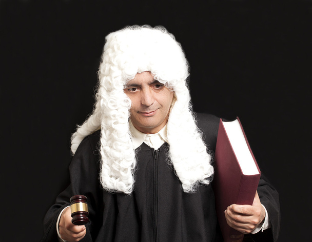 Portrait Of Male Lawyer Holding Judge Gavel And Book on black ba - Foto, Bild