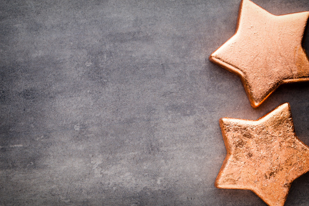 Bronze star. Christmas pattern. Background on the gray color. - Фото, зображення