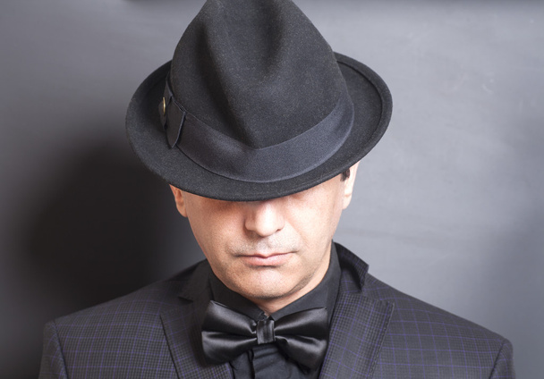 Man in black hat and black bowtie - Фото, зображення