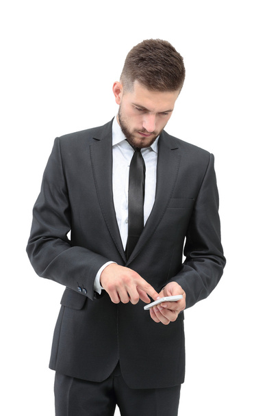 Handsome businessman in suit using the phone in office - Foto, imagen
