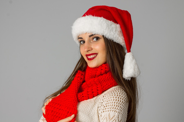 girl in santa hat and red scarf - Foto, Imagen