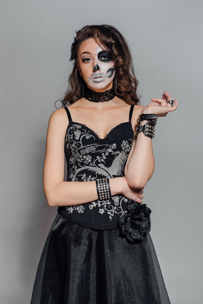 Portrait of young woman with skull make-up. - Zdjęcie, obraz