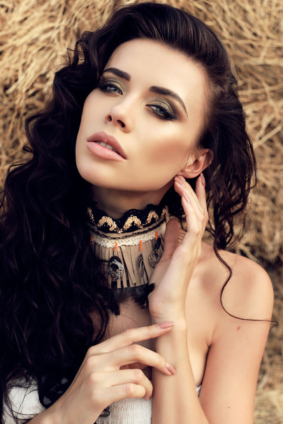 beautiful woman with dark hair  in casual clothes, posing on farm    - Zdjęcie, obraz