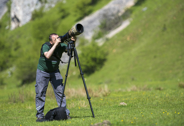 Professional travel on location and nature videographer/photographer (man) photographing and video nature and landscape outdoor. - Φωτογραφία, εικόνα