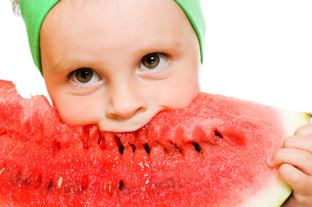 little boy eating a watermelon at a table - Foto, Imagen