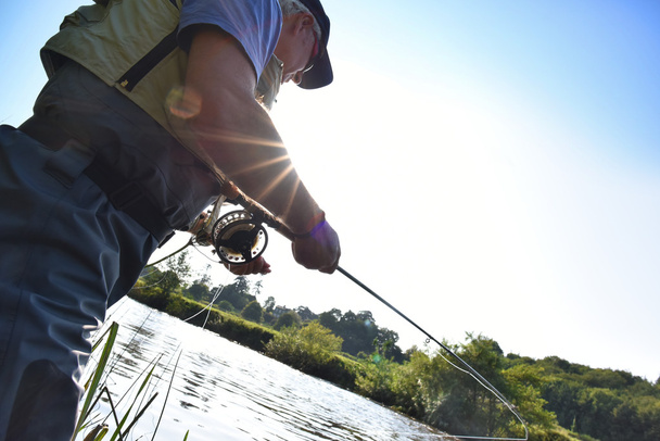 Fisherman fishing  in river - Foto, Imagen