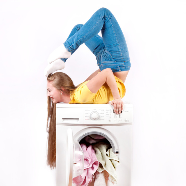 Young beautiful woman using a washing machine - Φωτογραφία, εικόνα