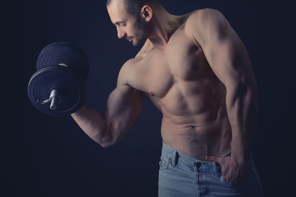 Strong man with dumbbells - Photo, Image