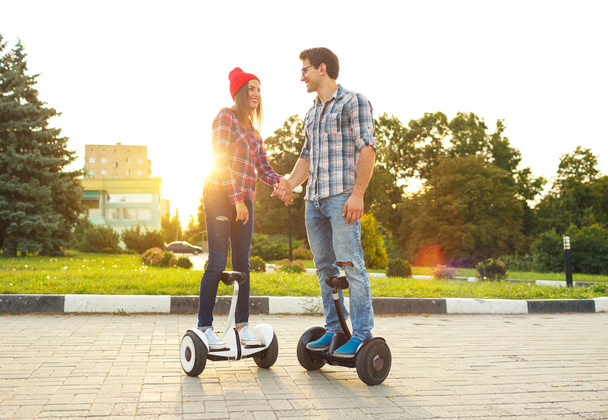 Young couple riding hoverboard - Photo, Image