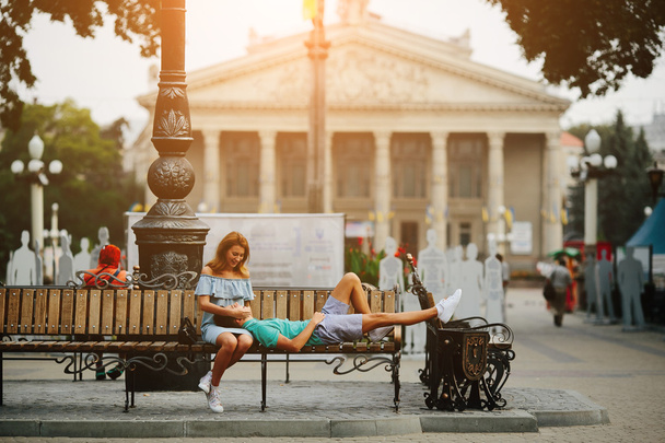 guy and girl sitting on a bench - Photo, Image