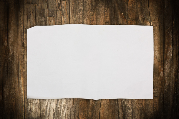 Paper sheet on a dark wooden background - Фото, зображення