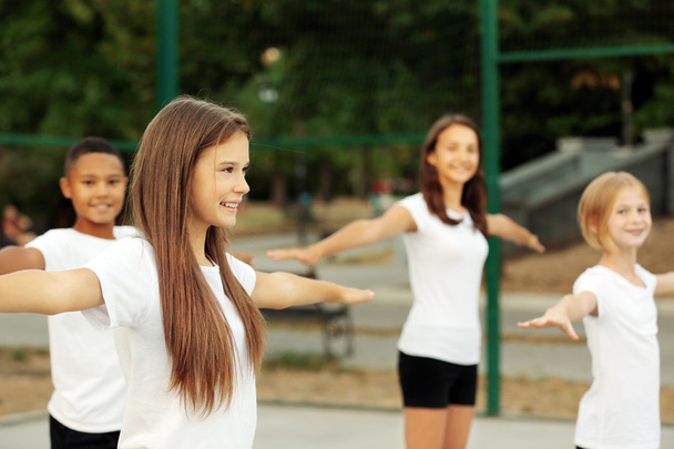 Students doing physical exercises on school yard - Foto, immagini