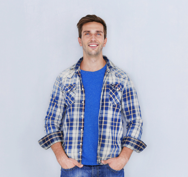 Young happy man on light background - Photo, Image