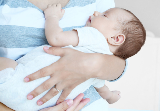Woman holding cute sleeping baby, close up view - Photo, Image