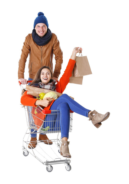 Young man carrying woman in trolley isolated on white - Foto, Imagen