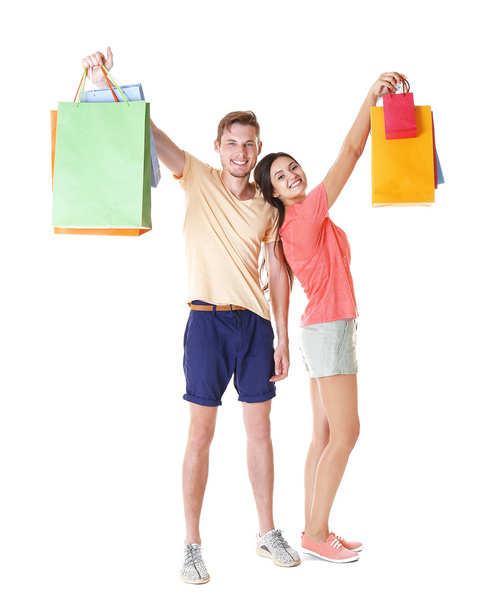 Happy couple with purchases isolated on white - Foto, Bild