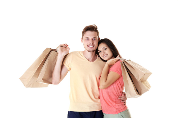 Happy couple with purchases isolated on white - Фото, зображення
