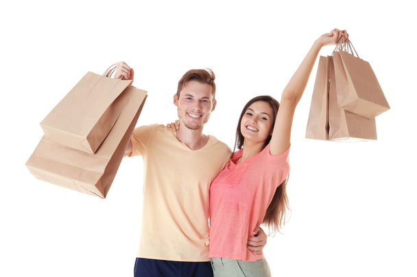 Happy couple with purchases isolated on white - 写真・画像