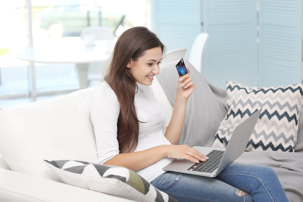Młoda kobieta zadowolony z laptopa i Dokonywanie zakupów online kartą kredytową - Zdjęcie, obraz