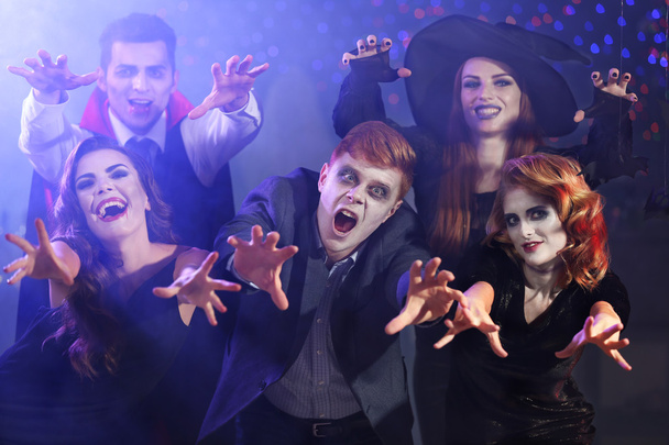 Young people in costumes having fun at Halloween party - Foto, Imagen