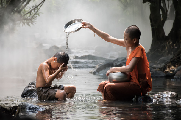 Monk and boy at river stream - Photo, Image
