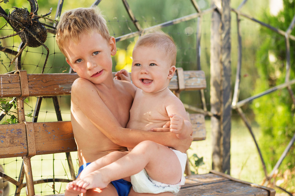Little boy holds on hands her baby sister - Foto, Bild