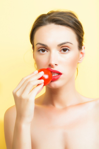 pretty girl with red tomato - 写真・画像