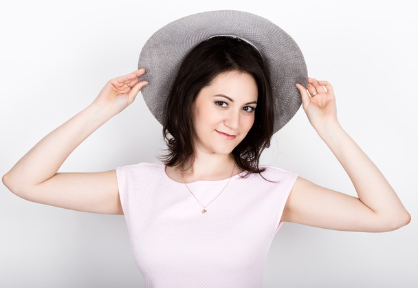 beautiful young brunette woman holding a broad-brimmed hat, she expression of different emotions - Foto, immagini