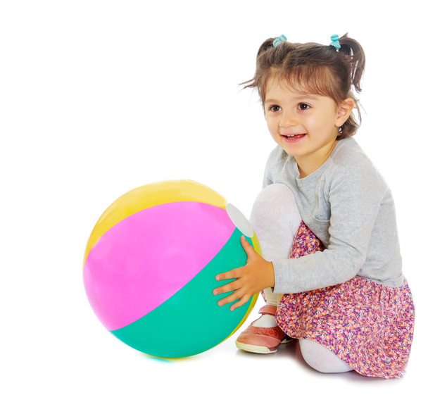 Little girl hugging a big ball - Фото, изображение
