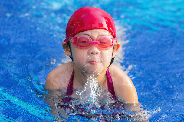 Child Swimming Breaststroke in Swimming Pool - Фото, изображение