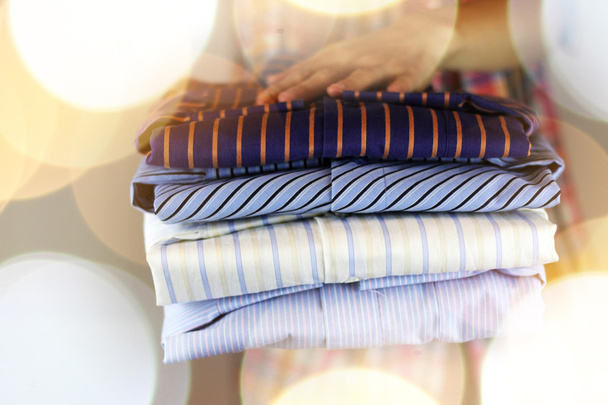 pile of ironing shirts and hand - Foto, afbeelding