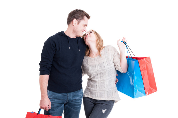Couple holding shopping bags and smiling - 写真・画像